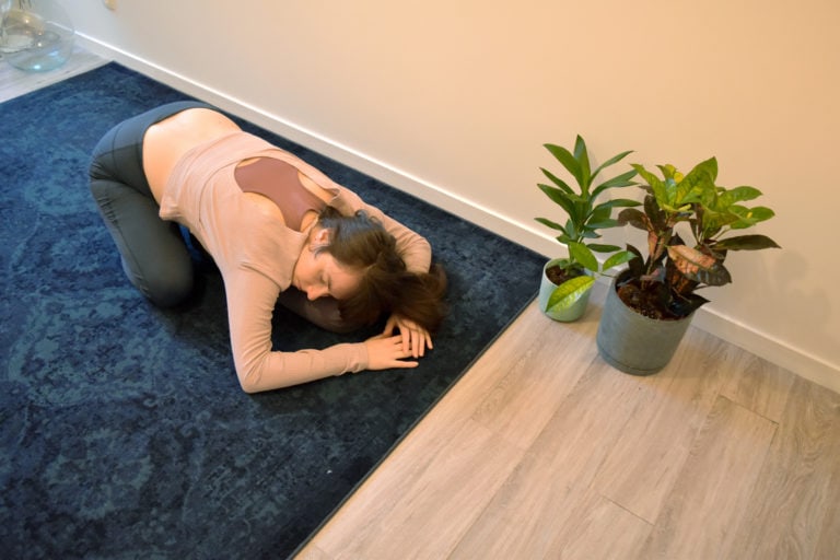 yoga réparateur : position de l'enfant avec un bolster