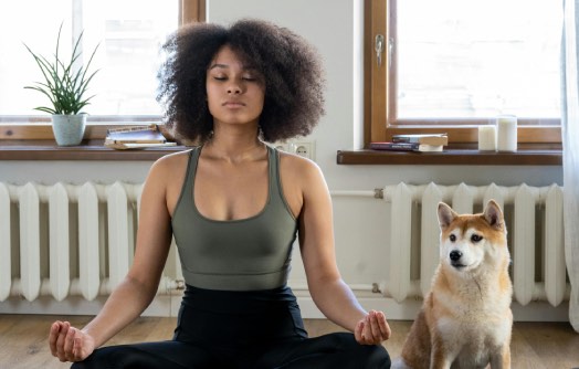 femme en méditation à côté d'un chien